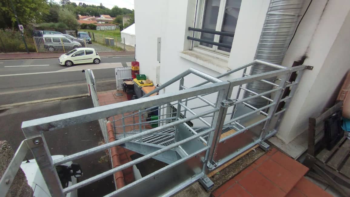 Gros plan sur un escalier métallique installé sur le côté d'une maison à Saint-Gilles-Croix-de-Vie, l'escalier a été traité par métallisation